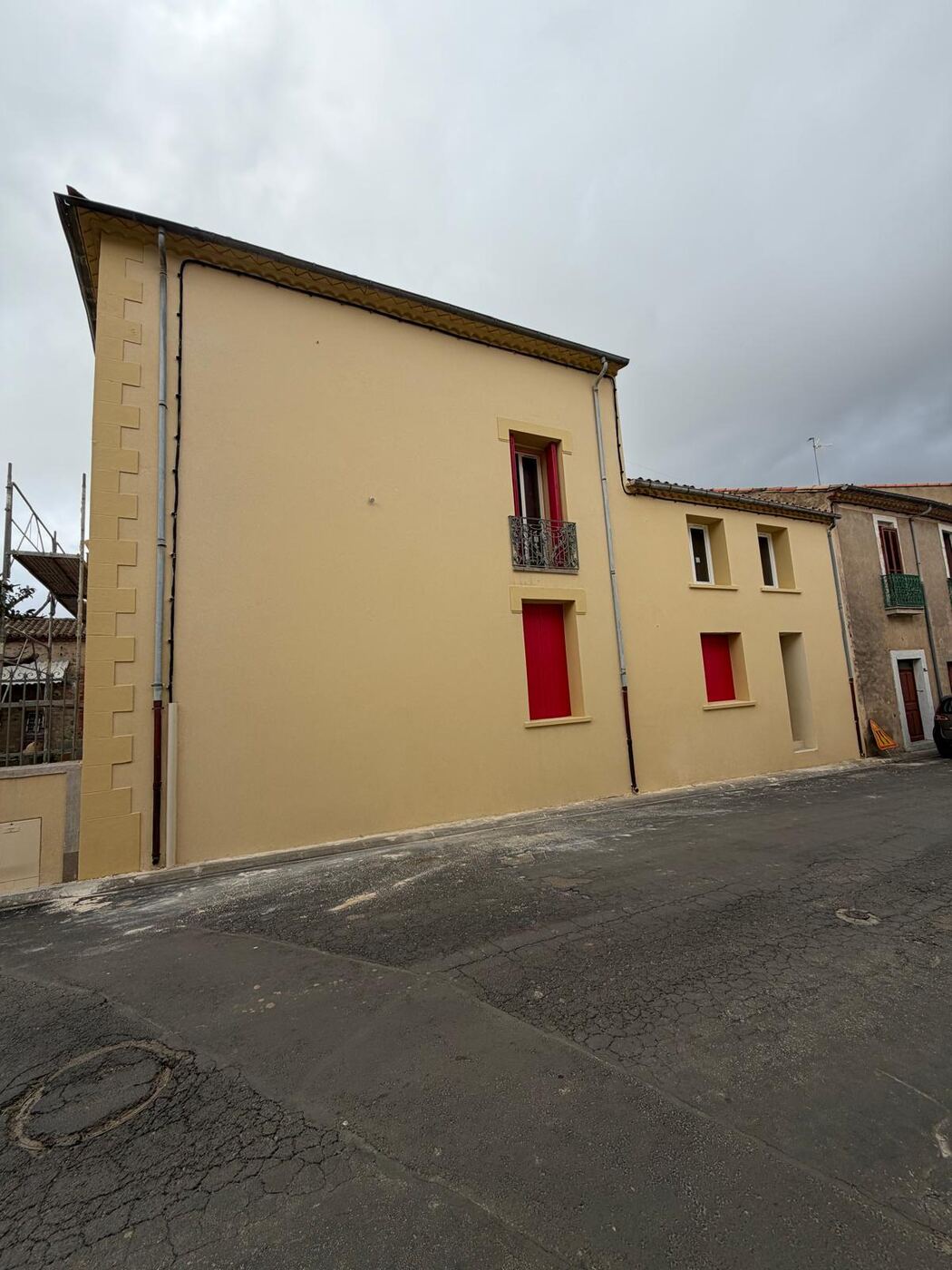 Façade enduit jaune et volets rouges après rénovation, réalisation LYS FACADE en Occitanie